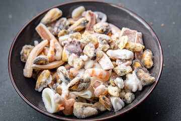 seafood cocktail frozen food mussels, rapan, octopus, scallop, squid healthy meal food snack on the table copy space food background rustic top view 