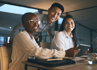 The nightshift team. Shot of a group of businesspeople using a digital tablet while working in a modern office late at night.