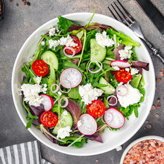 salad cheese, vegetable radish, tomato, cucumber, green lettuce mix green meal food snack on the table copy space food background rustic top view 