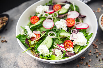 salad cheese, vegetable radish, tomato, cucumber, green lettuce mix green meal food snack on the table copy space food background rustic top view 