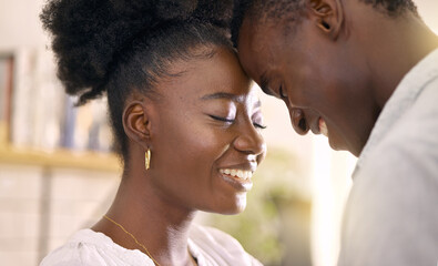Fototapeta premium The look of love looks good on you. Shot of a young couple relaxing together at home.