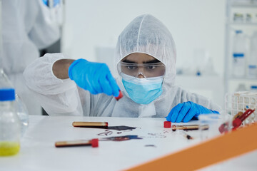 What a disaster. Shot of a young scientist cleaning up a mess at a lab.