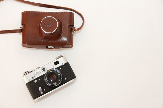 Antalya, Turkey, March 10, 2023. Vintage rare photo camera and a brown protective case for it on a white background