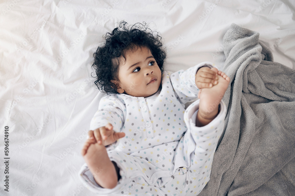 Canvas Prints My toes look yummy. Shot of a sweet baby girl lying on a bed at home.