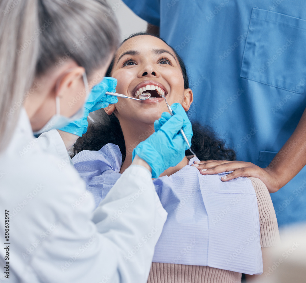 Poster No skimping on the work. Shot of a young woman having a dental checkup.