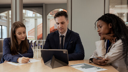 Diverse ethnic team of professional businesspeople meeting discussion in office. Businessman and diversity colleagues talking planning and brainstorming corporate startup project strategy together.