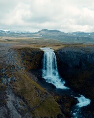 Drone Aerial of Kerlingarfoss Waterfall near Olafsvik on Iceland's Snafellsnes peninsula. High quality photo. Beautiful waterfall with the Snaefellsjokull Volcano in the background.