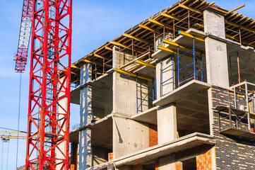 A frame made of load-bearing reinforced concrete walls during the construction of a multi-storey building. Reinforcement of reinforced concrete columns. Construction of high-rise buildings.