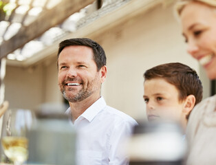 Fototapeta premium Happy, fed and relaxed. Shot of a family enjoying a meal together.