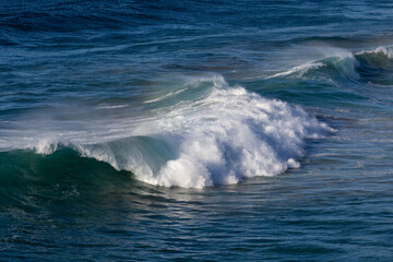 Beautiful wave breaking on the beach shore.
