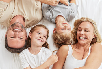 This is what were doing. Shot of a beautiful young family bonding in bed together.