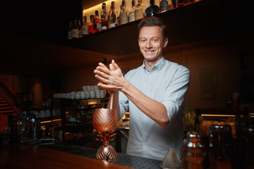 male bartender prepares a cocktail 