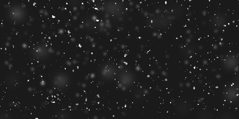 Snowstorm texture. Bokeh lights on black background, shot of flying snowflakes in the air