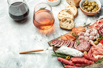 Appetizers with differents antipasti, snacks and wine. Meat antipasto platter. Sausage, ham, tapas,...