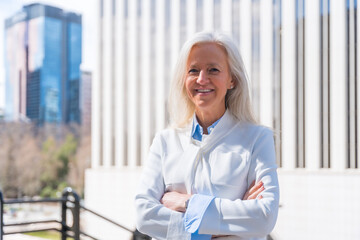 Portrait of executive professional senior woman in a business area, office in commercial district