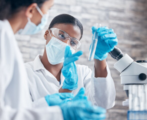 Notice anything odd about this. Shot of a young scientist working with test tubes with her colleague in a lab.