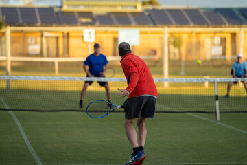 Amateur Tennis player, playing tennis at a tournament and match on grass in Europe 