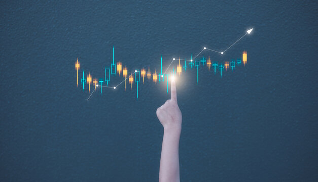 investment financial concept, kid girl hand pointing to virtual trading graph on blurred concreate wall background - Powered by Adobe