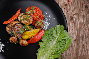 vegetarian grilled veggies and mushrooms on black plate