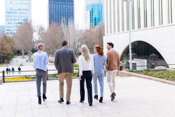 Walking out of work. Group executives or businessmen and businesswoman in a business area
