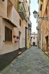 Obraz premium A narrow street among the old houses of Sessa Aurunca, a small town of Caserta province, Italy.