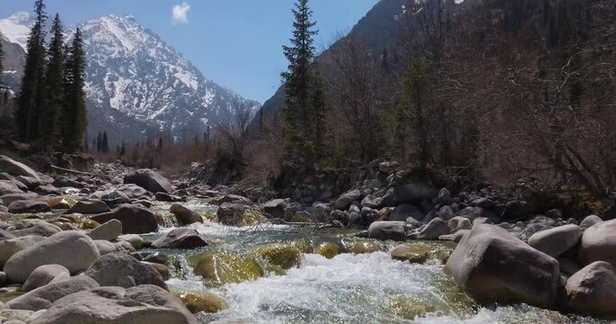 the course of a mountain river in early spring, mountains on the horizon