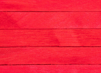 Old red wooden background. Wooden textured background. Wooden painted red boards are located vertically in a row.