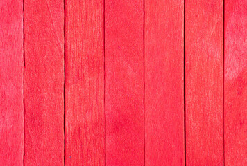 Old red wooden background. Wooden textured background. Wooden painted red boards are located vertically in a row.