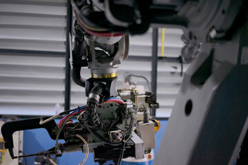 Engineer work at robotic arm factory.