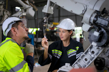 Engineer work at robotic arm factory.