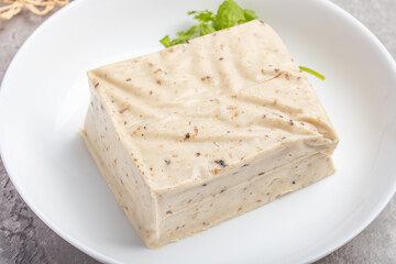 black sesame tofu grains tofu in a white plate