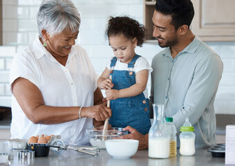 I even taught your dad this recipe. Shot of an adorable little girl baking with her father and grandmother at home.