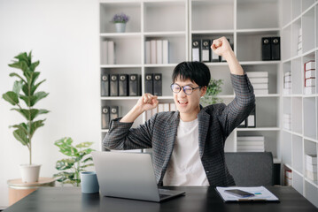 Portrait of young man sitting at his desk in the office