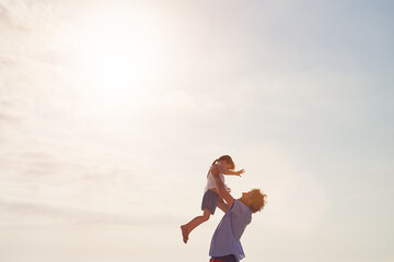 Ill always be here to catch you. Shot of a father lifting his daughter into the air at the beach.