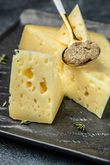 Pieces of delicious cheese with holes and truffle paste. vertical image. place for text