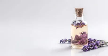 Fototapeten Bottles of essential oil for aromatherapy, alternative medicine and fresh lavender flowers on light background. Banner, space for text. © Алекс Ренко