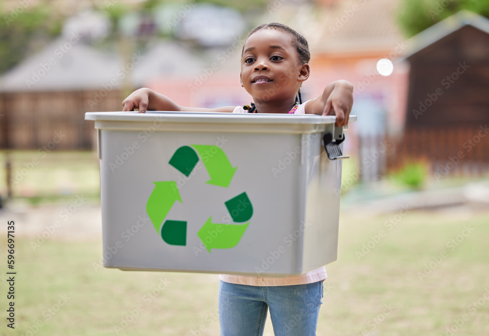 Sticker taking care of the environment. shot of a little girl carrying a recycling box outside.