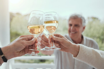 Growing up, I learned lifes important lessons at dinner. Shot of an elderly man toasting with unrecognizable family memers at home.