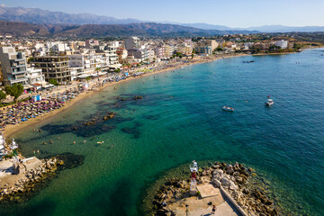 Aerial view of a busy beach in the popular resort town of Nea Chora in Chania, Crete (Greece)
