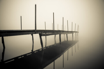 bridge over the water
mooring for boats on the lake in calm water in the fog