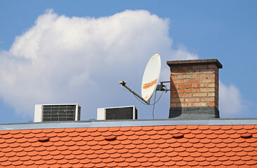 Antenna and air conditioners on the roof of a house