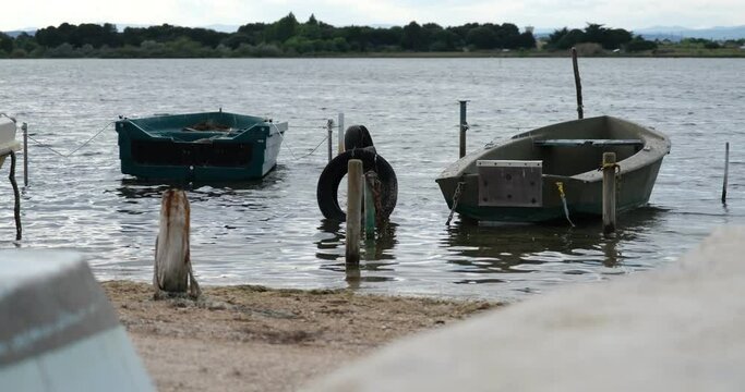 4K Calm Lake Water Small Fishing Boats Moored Near Shore Mediterranean Herault