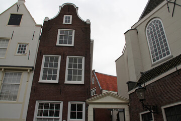 Fototapeta na wymiar old brick houses and church at a beguinage (begijnhof) in amsterdam (the netherlands) 