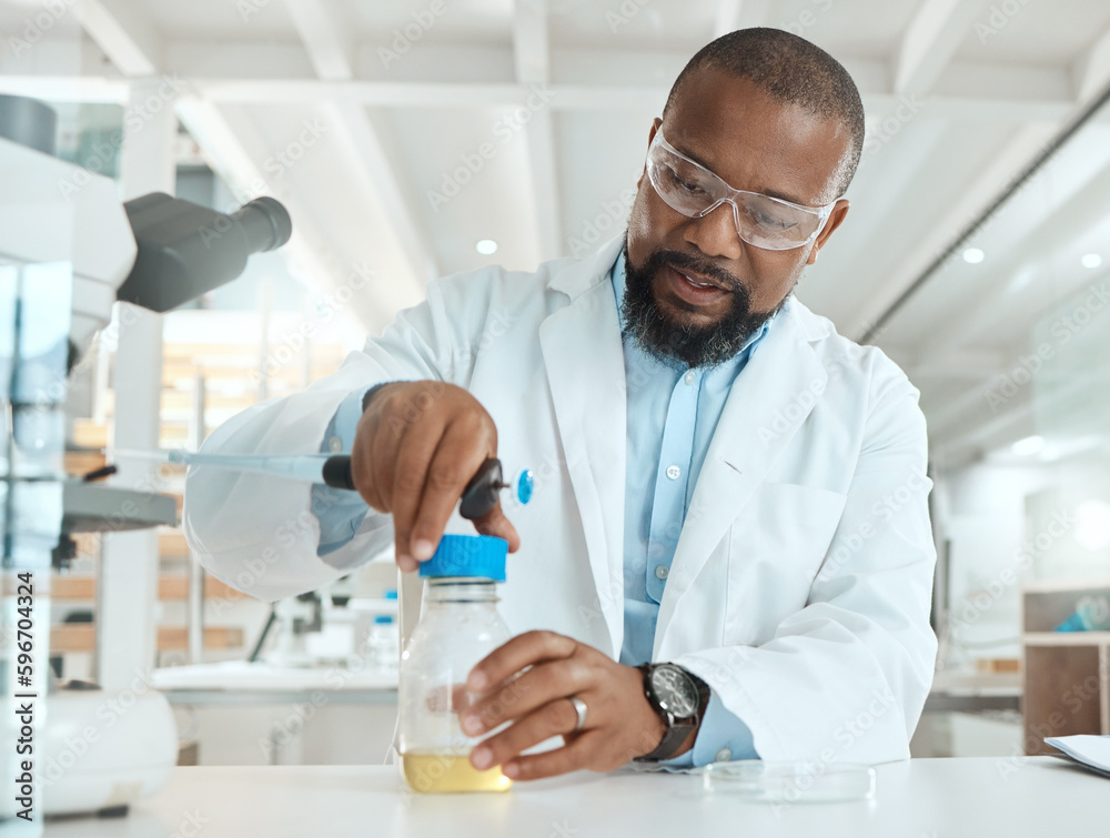 Poster lets see whats causing the infection. shot of a handsome mature scientist sitting alone in his labor