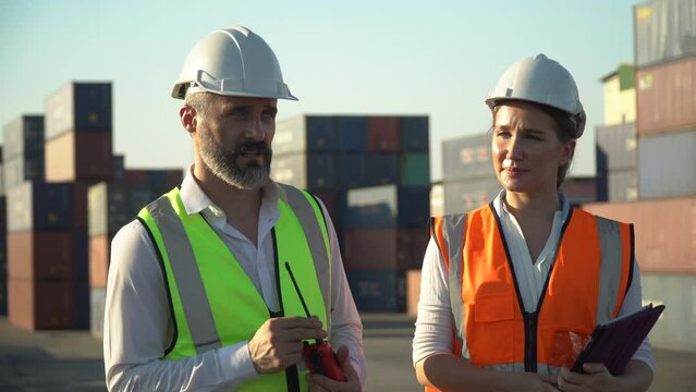 foreman and harbor worker woman using digital tablet control forklift moving down Containers box to checking list inventory loading at warehouse logistic in Cargo . import export shipping business
