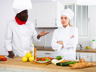 Chef dissatisfied with prepared dish of female cook