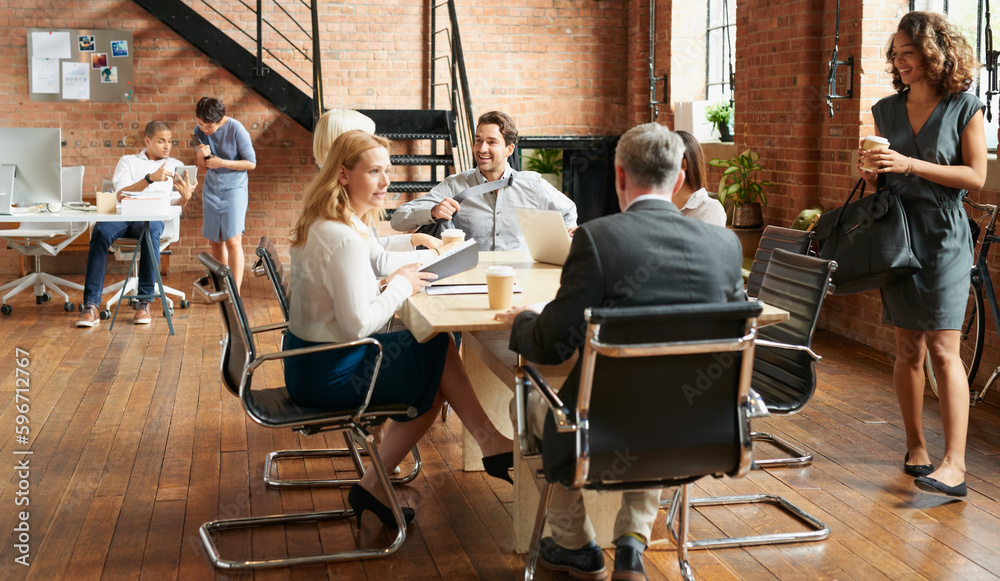 Poster time to get down to some exciting business. shot of a group of businesspeople having a meeting in an