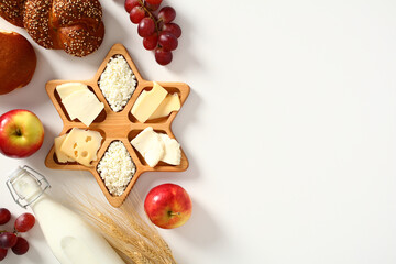 Shavuot food on white table. Jewish holiday Shavuot celebration concept.