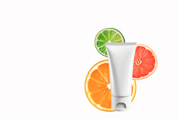Mock-up of a tube of face cream or peel with vitamin C on a white background. Side view, space for...