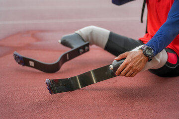 Athlete runner with prosthetic legs at track stadium